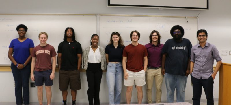 This photo shows nine students posing for a group photo.