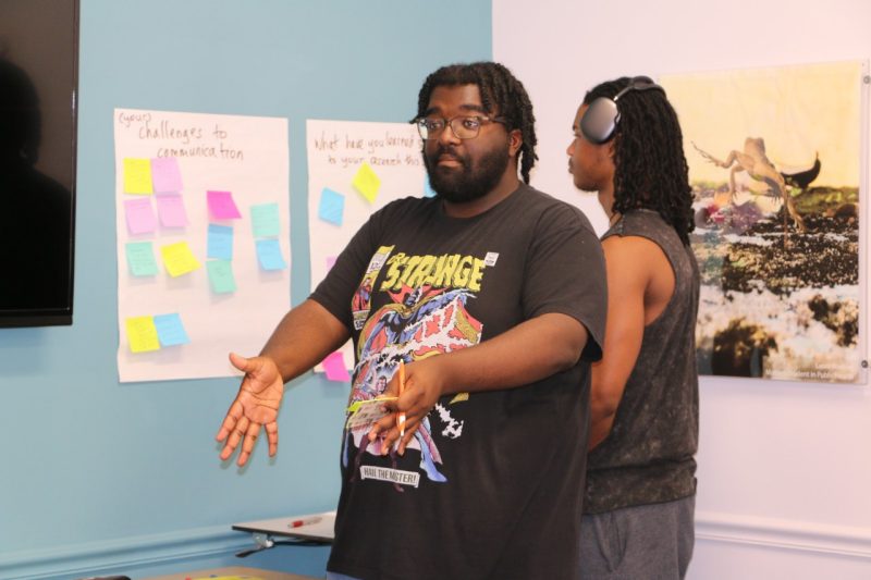 This photo shows a student explaining challenges in communication.