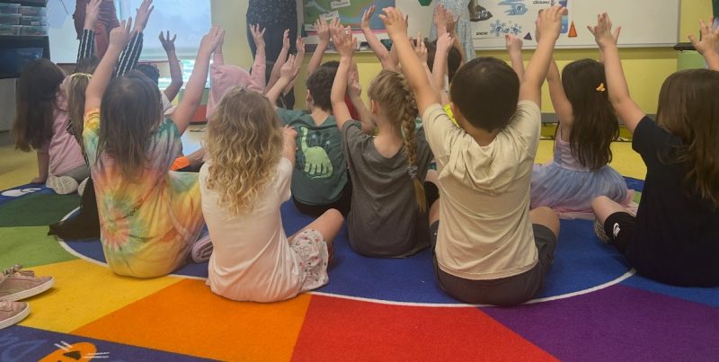 The high school students guided the kindergarteners through an interactive song and dance illustrating the water cycle.