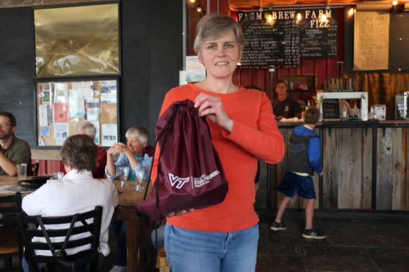 A representative from the Blue Birds team holds up a their "swag bag" trophy.