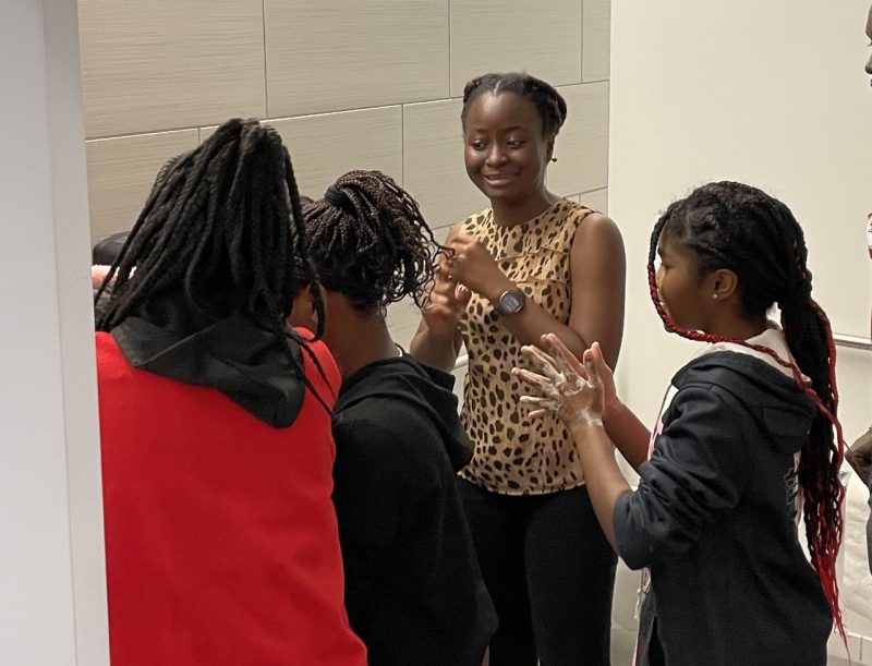 Ama Essuman hand washing A picture of an adult women and three children washing their hands with soap.