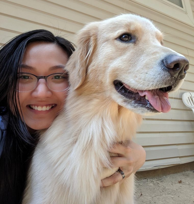 Ny Luong takes a selfie with a large dog.