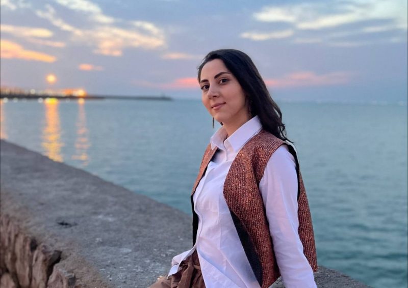 Reyhane Rastgoo 7 Photo shows a researcher posing for a photo near a body of water.