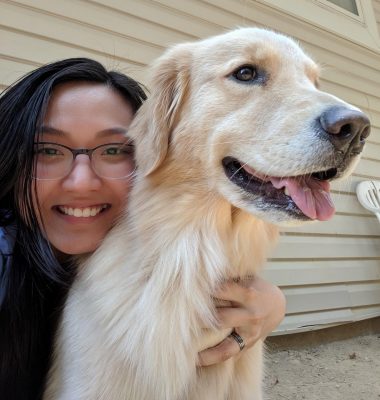 Ny Luong takes a selfie with a large dog.