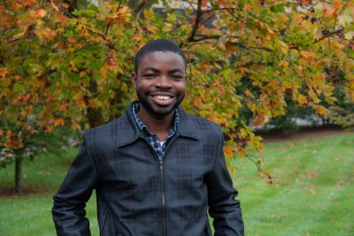 Abraham Adeyemo posing for a picture outdoors.