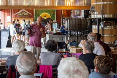 A featured expert talks about the drone in his hands in front of a curious audience.